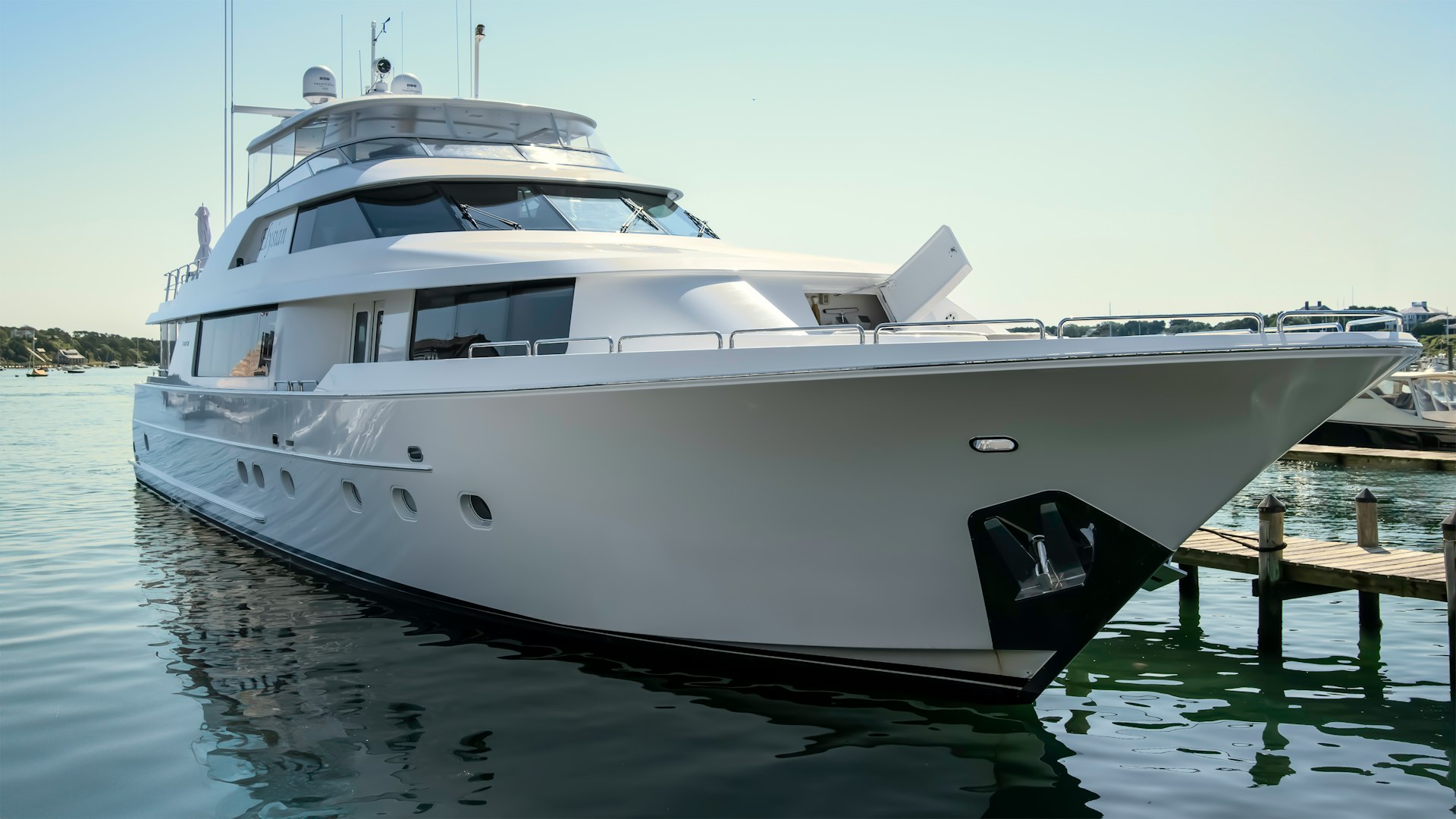 A large white boat docked at a dock